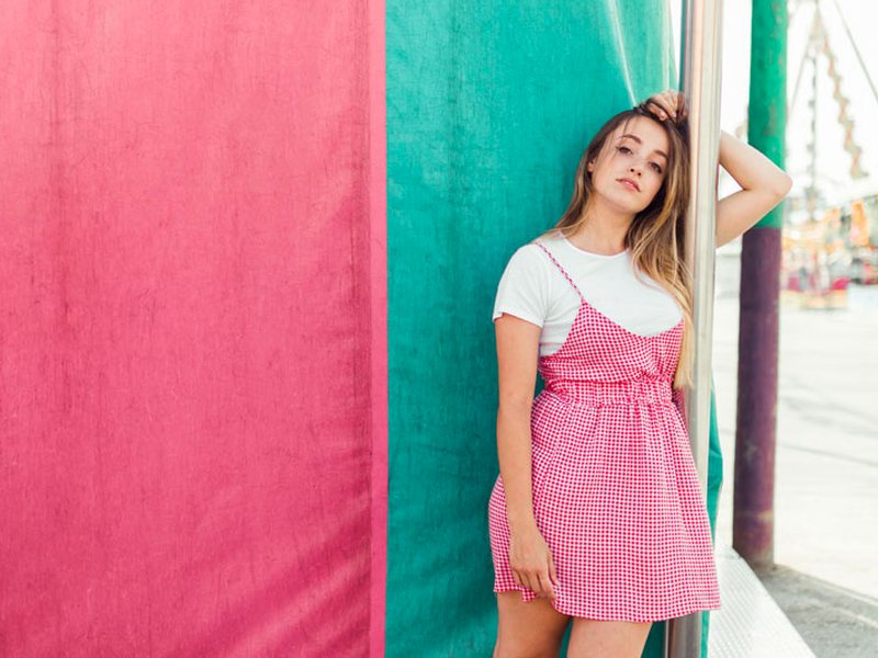 Woman smiling by a colorful wall